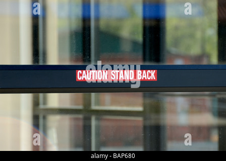 Caution Stand Back sign on automatic door Stock Photo