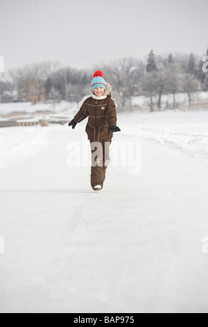 9 year old girl skating on Red River, Winnipeg, Canada Stock Photo