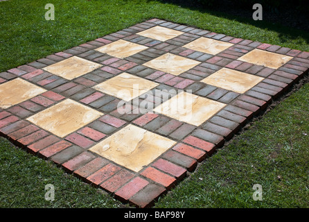 Brick pattern patio base set in a lawn Stock Photo