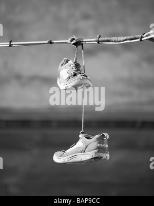 Shoeing, image showing the practice of throwing shoes with shoelaces tied Stock Photo