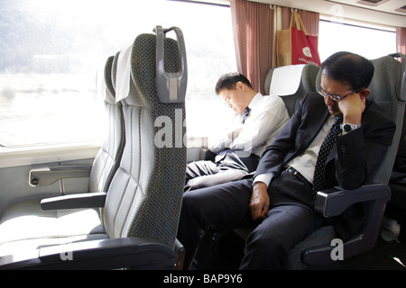 Japanese businessmen sleeping on a train Japan Stock Photo