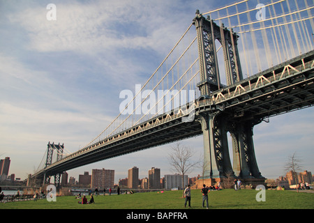 A view of the south side of Manhattan Bridge, viewed from the edge of Empire Fulton Ferry Park, Dumbo, New York. Stock Photo