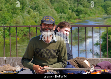 Poor family sitting in cart in Latvian countryside Stock Photo