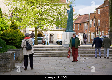 Elderly tourists taking pictures in Chichester, West Sussex, UK Stock Photo