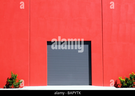 Grey roller garage door in red brick wall Stock Photo