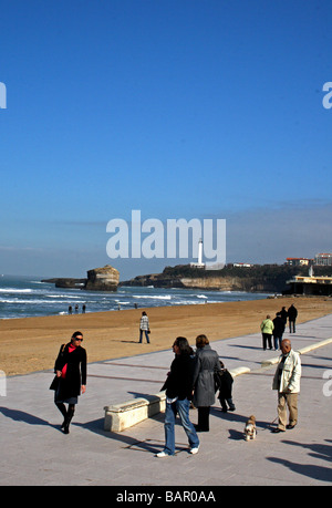 People walking along the sea front of Biarritz, in the Pays Basque region of south west France. Stock Photo
