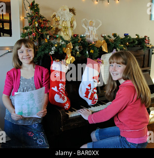 Children singing and playing the piano at Christmas Stock Photo