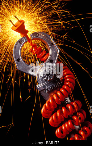 Robotic arm holding sparking cord Stock Photo