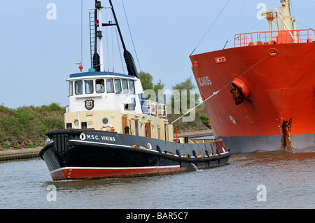 Tugboat MSC Viking guiding the bulk chemical oil products tanker Acavus Stock Photo