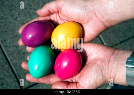 Coloured easter eggs held in palm Stock Photo