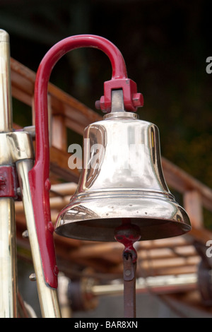 Close up of brass bell on 1916 Dennis N type pump / escape fire engine during vintage commercial vehicle rally, Brighton. Stock Photo