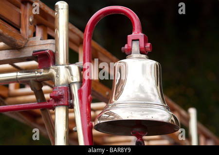 Close up of brass bell on 1916 Dennis N type pump / escape fire engine during vintage commercial vehicle rally, Brighton. Stock Photo