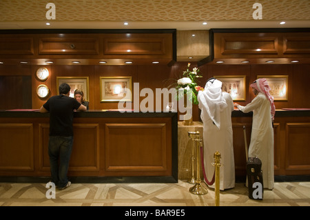 Arab guests at the front desk reception of Cairo Marriott Hotel & Omar Khayyam Casino in Zamalek district on the Nile island of Gezira, Cairo Egypt Stock Photo