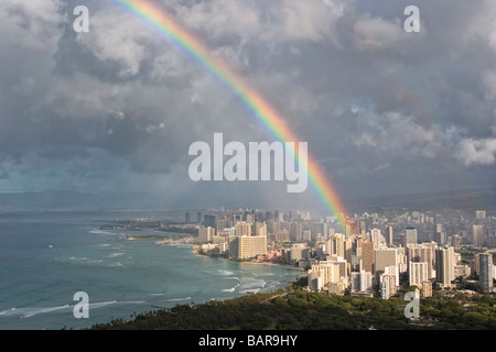 A rainbow over Honolulu and Waikiki Beach, seen from Diamond Head. Stock Photo