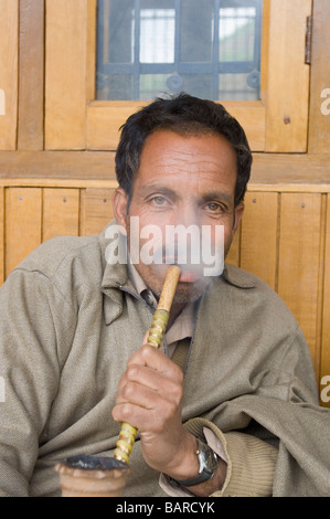 Portrait of a man smoking hookah, Jammu And Kashmir, India Stock Photo
