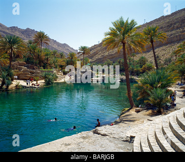 picturesque green and turquoise pools, surrounded of palms and harsh mountains make Wadi Bani Khalid to a popular destination Stock Photo