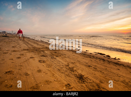 walking on the beach at night seen through a wide angle lens Stock Photo