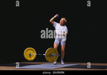 Female Olympic style weightlifter in action Stock Photo