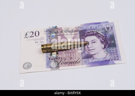 Bullet over British money Stock Photo