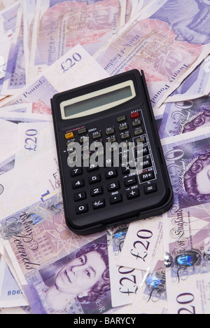 Calculator of a pile of British money Stock Photo