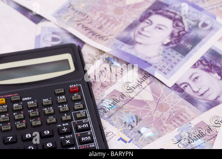 Calculator of a pile of British money Stock Photo