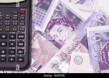 Calculator of a pile of British money Stock Photo