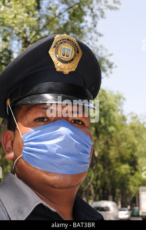 Closeup of a Mexican police officer who protects himself with a face mask against influenza Stock Photo