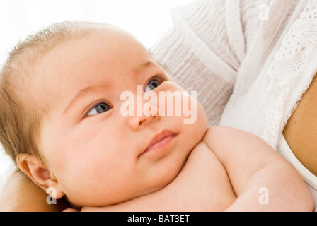 baby looking up at mother Stock Photo