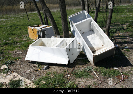 old fridge freezers dumped in field in countryside Stock Photo