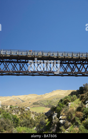 Cyclists on Five Mile Creek Bridge Otago Central Rail Trail near Hyde Central Otago South Island New Zealand Stock Photo