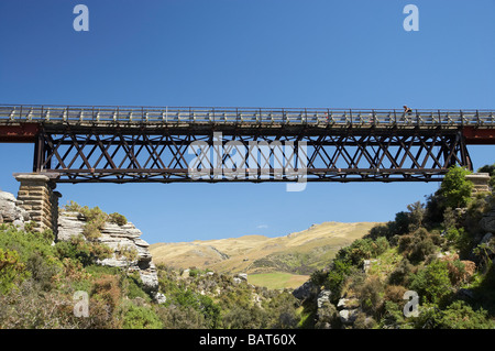 Cyclists on Five Mile Creek Bridge Otago Central Rail Trail near Hyde Central Otago South Island New Zealand Stock Photo