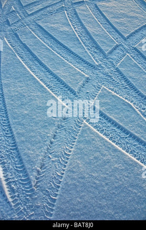 Wheel trails of tires in the frost snow Stock Photo