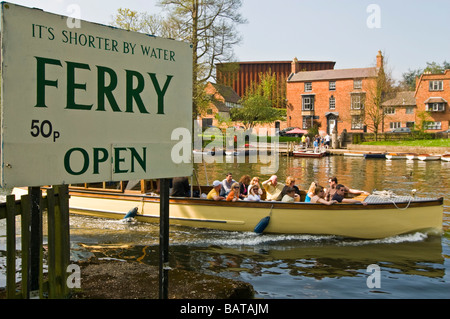 Horizontal wide angle of a pleasure boat on a guided tour full of tourists on the river Avon on a bright sunny day Stock Photo