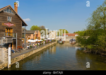 Horizontal wide angle of people sitting outside Cox's Yard alongside the River Avon on a bright sunny day Stock Photo