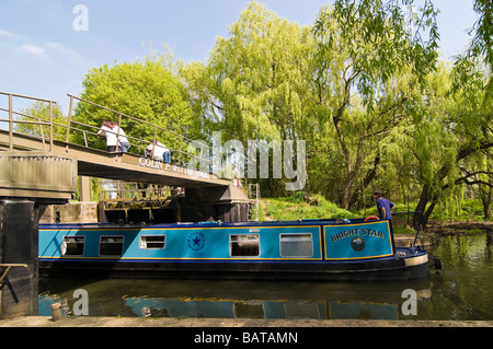 Horizontal wide angle of a traditional narrowboat navigating the entrance of an empty lock on the River Avon on a sunny day Stock Photo