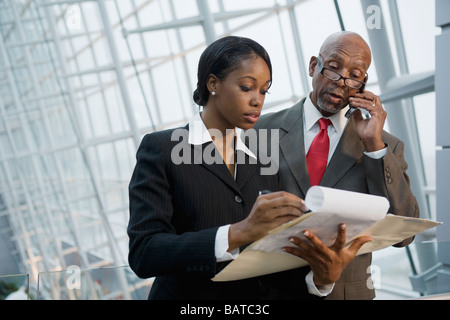 African businesspeople reviewing paperwork Stock Photo