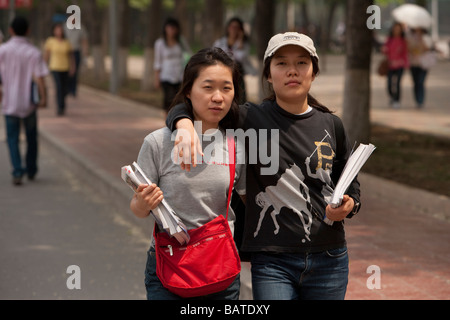 Beijing China Two girl university students walk together on the campus Stock Photo