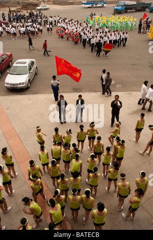 School children arriving at the city sports stadium to rehearse for a parade in front of Party Leaders Changchun Stock Photo
