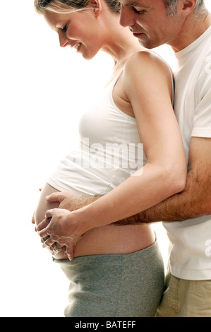 Expectant parents. Happy pregnant woman and her partner resting their hands on herswollen abdomen. Stock Photo