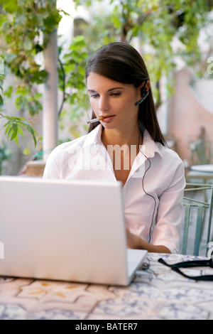 woman sitting in balcony with laptop Stock Photo