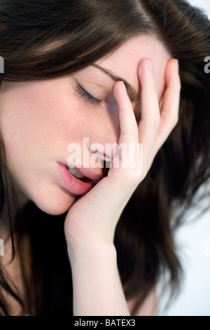 Stress. Stressed woman in hertwenties holding her head in her hands. Stock Photo