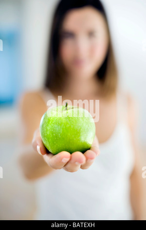 Apple held in a woman's hand. Stock Photo