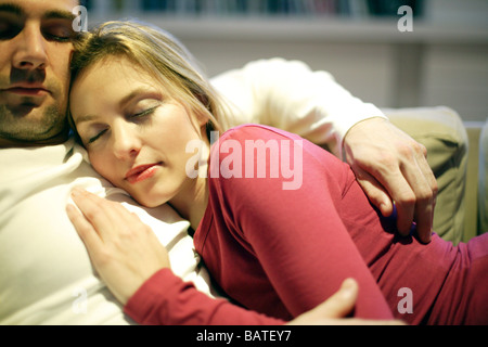 Couple sleeping on a sofa. Stock Photo