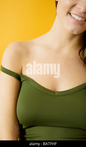 A woman's upper body, with a bra strap falling off her shoulder Stock Photo  - Alamy