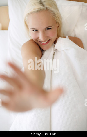Happy woman playing in bed. Stock Photo