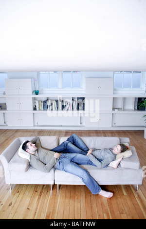Couple relaxing on a sofa. Stock Photo