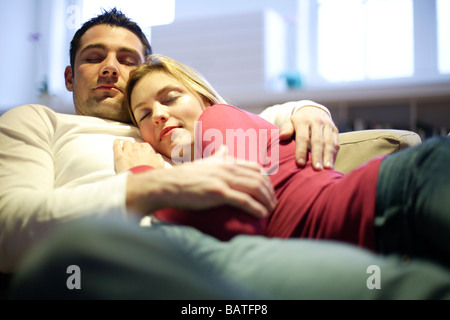 Couple sleeping on a sofa. Stock Photo