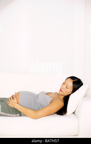 Pregnant woman holding her swollen abdomen. Stock Photo
