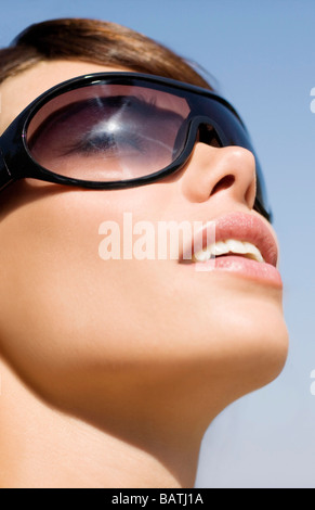 Woman wearing sunglasses. The lenses protect the eyes from the UV radiation in sunlight. Stock Photo