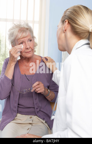 Breaking bad news. General practitioner breaking bad news to an elderly patient. Stock Photo